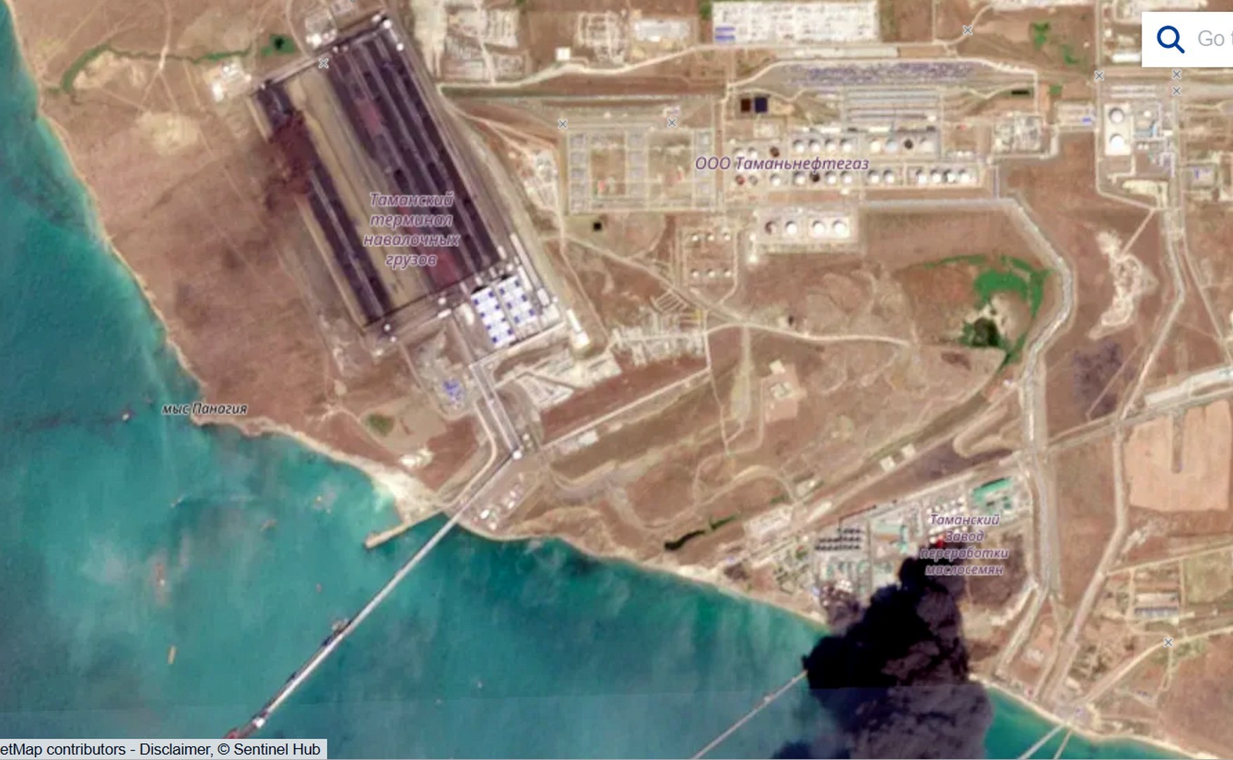 Sentinel-2: intact Tamanneftegaz tank farm and black smoke above the facility labelled as an oilseed processing plant